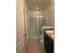 Bathroom with double vanity, shower, and grab bars at 146 Prairie Falcon Dr, Groveland, FL 34736