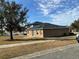 Rear view of house with solar panels and a patio at 146 Prairie Falcon Dr, Groveland, FL 34736