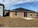 Rear view of house with solar panels and a patio at 146 Prairie Falcon Dr, Groveland, FL 34736