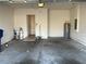 Empty garage with concrete floor, water heater, and access door at 146 Prairie Falcon Dr, Groveland, FL 34736