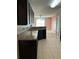 Kitchen with dark cabinets and granite counters at 146 Prairie Falcon Dr, Groveland, FL 34736