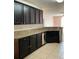 Kitchen with dark cabinets and dishwasher at 146 Prairie Falcon Dr, Groveland, FL 34736