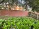 Backyard with brick wall and lush greenery at 103 Shire Ct, Sanford, FL 32773