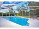 Relaxing screened pool area with lounge chairs and a fountain at 116 Reflection Blvd, Auburndale, FL 33823