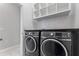 Convenient laundry room with washer, dryer, and shelving at 12233 Satire St, Orlando, FL 32832