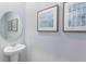 Small bathroom with pedestal sink and framed art at 1511 Isleta Loop, Kissimmee, FL 34741