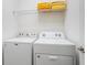 Bright laundry room, features washer, dryer, and shelving at 2613 Calistoga Ave, Kissimmee, FL 34741