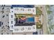 Aerial view of a beachfront community with a pool and ocean at 4155 S Atlantic Ave # 210, New Smyrna Beach, FL 32169