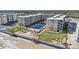 Aerial view of beachfront property with pool and shuffleboard at 4155 S Atlantic Ave # 210, New Smyrna Beach, FL 32169