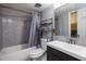 Clean bathroom with shower/tub combo and gray tile at 4155 S Atlantic Ave # 210, New Smyrna Beach, FL 32169