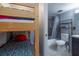 Small bedroom with a bunk bed and ensuite bathroom at 4155 S Atlantic Ave # 210, New Smyrna Beach, FL 32169