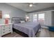 King-size bed, ocean view, and ceiling fan in bedroom at 4155 S Atlantic Ave # 210, New Smyrna Beach, FL 32169