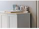 White cabinet with beach-themed welcome sign at 4155 S Atlantic Ave # 210, New Smyrna Beach, FL 32169