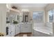 Elegant bathroom with double vanity, soaking tub, and separate shower at 422 Troon Cir, Davenport, FL 33897