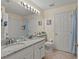 Clean bathroom with granite countertops and a double vanity at 422 Troon Cir, Davenport, FL 33897