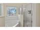 Clean bathroom with a bathtub and shower at 422 Troon Cir, Davenport, FL 33897