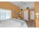 Bright bedroom with a king-size bed and view of the backyard at 422 Troon Cir, Davenport, FL 33897