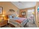 Charming bedroom with a queen-size bed and window seat at 422 Troon Cir, Davenport, FL 33897