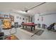 Game room in garage, pool table, seating, and basketball game at 422 Troon Cir, Davenport, FL 33897