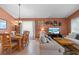 Combined living and dining area with light beige colored sofa and wooden dining table at 422 Troon Cir, Davenport, FL 33897