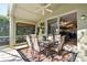 Screened patio with table and chairs, adjacent to kitchen at 422 Troon Cir, Davenport, FL 33897