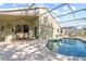 Relaxing kidney-shaped pool with patio and screened enclosure at 422 Troon Cir, Davenport, FL 33897