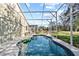 Inviting kidney shaped pool with screened enclosure at 422 Troon Cir, Davenport, FL 33897