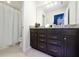 Bathroom with granite countertop, dark brown vanity, and shower at 4322 Lana Ave, Davenport, FL 33897