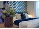 Bedroom with geometric patterned wall and blue velvet bed at 4322 Lana Ave, Davenport, FL 33897