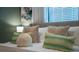 Close-up view of bedspread with patterned pillows and a white fluffy ball at 4322 Lana Ave, Davenport, FL 33897
