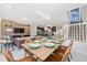 Open concept dining area with a wooden table and leather chairs, adjacent to a living room and kitchen at 4322 Lana Ave, Davenport, FL 33897