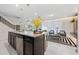 Granite kitchen island with seating and a view into the living room at 4322 Lana Ave, Davenport, FL 33897
