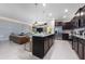 Spacious kitchen with dark cabinetry, granite countertops, and stainless steel appliances at 4322 Lana Ave, Davenport, FL 33897