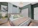 Main bedroom with a king-size bed, green walls, and a walk-in closet at 4322 Lana Ave, Davenport, FL 33897