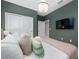 Main bedroom with a king-size bed, green walls, and a large TV at 4322 Lana Ave, Davenport, FL 33897