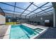 Private screened pool with lounge chairs and grill at 4322 Lana Ave, Davenport, FL 33897
