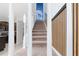 Modern staircase with white railings and carpeted steps at 4322 Lana Ave, Davenport, FL 33897