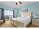 Main bedroom with king-size bed and private balcony at 7606 Sandy Ridge Dr # 401, Reunion, FL 34747