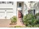 Front door entrance with landscaping and brick walkway at 8025 Gray Kingbird Dr, Winter Garden, FL 34787