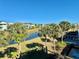 Community overview featuring lake, lush landscaping, and colorful homes at 8035 Surf St, Kissimmee, FL 34747