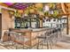 Outdoor bar with hanging plants and modern stools at 8035 Surf St, Kissimmee, FL 34747