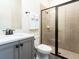 Modern bathroom with gray vanity, white toilet and a glass shower at 8035 Surf St, Kissimmee, FL 34747