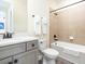 Clean bathroom with a shower/tub combo and gray vanity at 8035 Surf St, Kissimmee, FL 34747