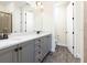 Modern bathroom with double vanity, gray cabinets, and a large mirror at 8035 Surf St, Kissimmee, FL 34747