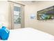Bedroom with a queen bed and a wall-mounted TV at 8035 Surf St, Kissimmee, FL 34747