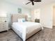 King bed, ceiling fan, and access to private bathroom at 8035 Surf St, Kissimmee, FL 34747
