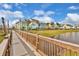 Wooden boardwalk path overlooking pond and homes at 8035 Surf St, Kissimmee, FL 34747