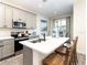 Modern kitchen with gray cabinets, quartz counters, and stainless steel appliances at 8035 Surf St, Kissimmee, FL 34747