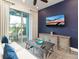 Cozy living room with a large TV and access to the patio at 8035 Surf St, Kissimmee, FL 34747