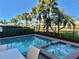 Shared pool and spa with patio furniture and lake view at 8035 Surf St, Kissimmee, FL 34747